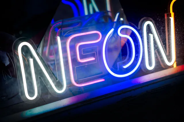 A close-up view of a vibrant neon sign showcasing bright colors and luminescence. Why Neon Sign Restoration Costs More in Canadian Winters
